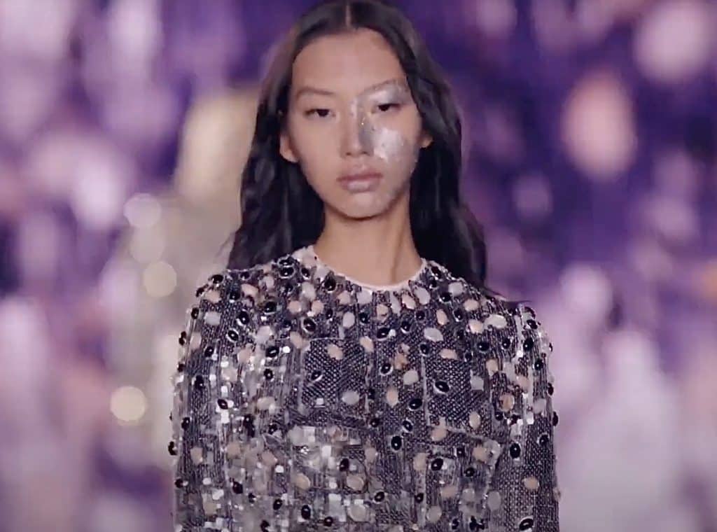 girl with silver sequined top and silver makeup at Paris fashion week 2024